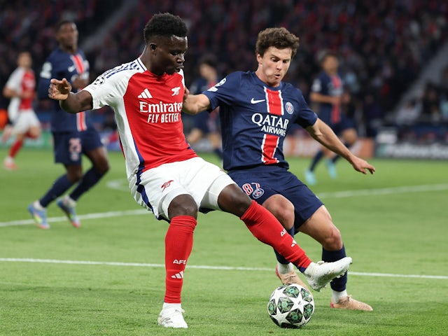 Paris Saint-Germain's Joao Neves battles with Arsenal's Bukayo Saka on May 7, 2025